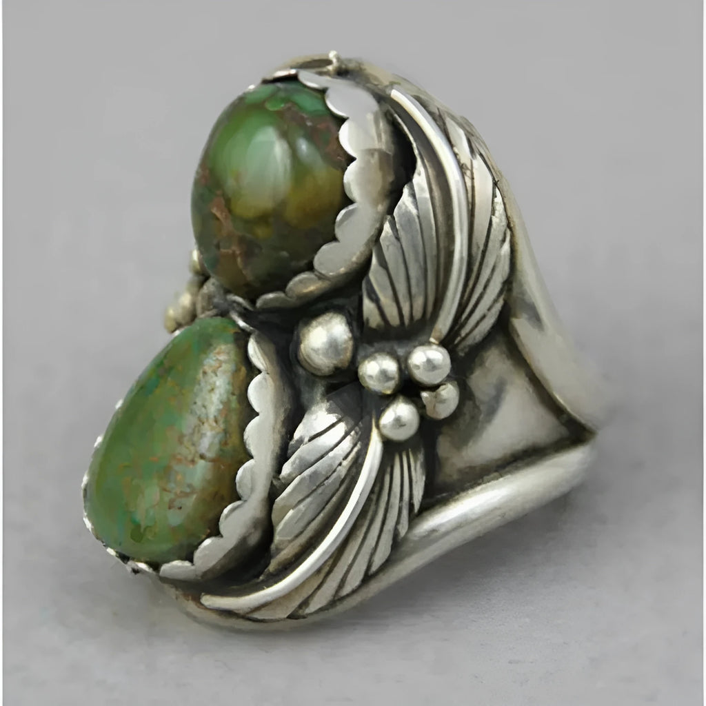 Women's retro geometric alloy ring with a turquoise inlaid design, shown on a finger.