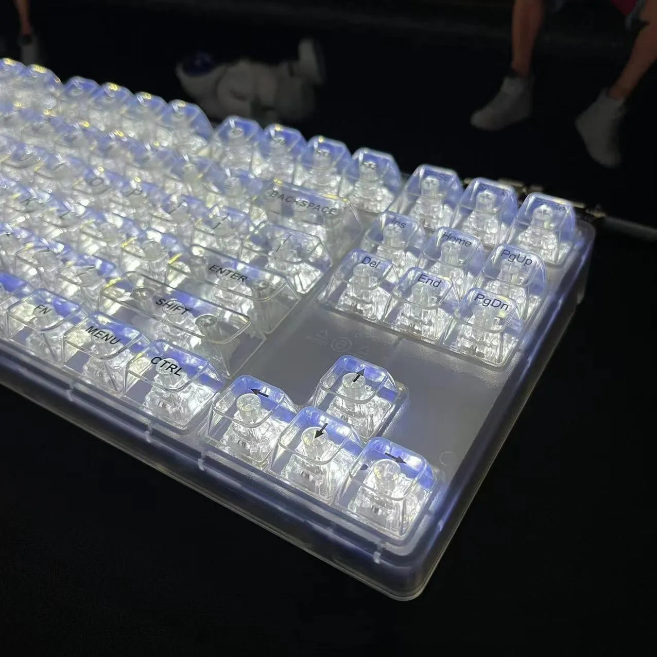 Transparent plastic keyboard key caps arranged as complete 132-key set for mechanical keyboard replacement