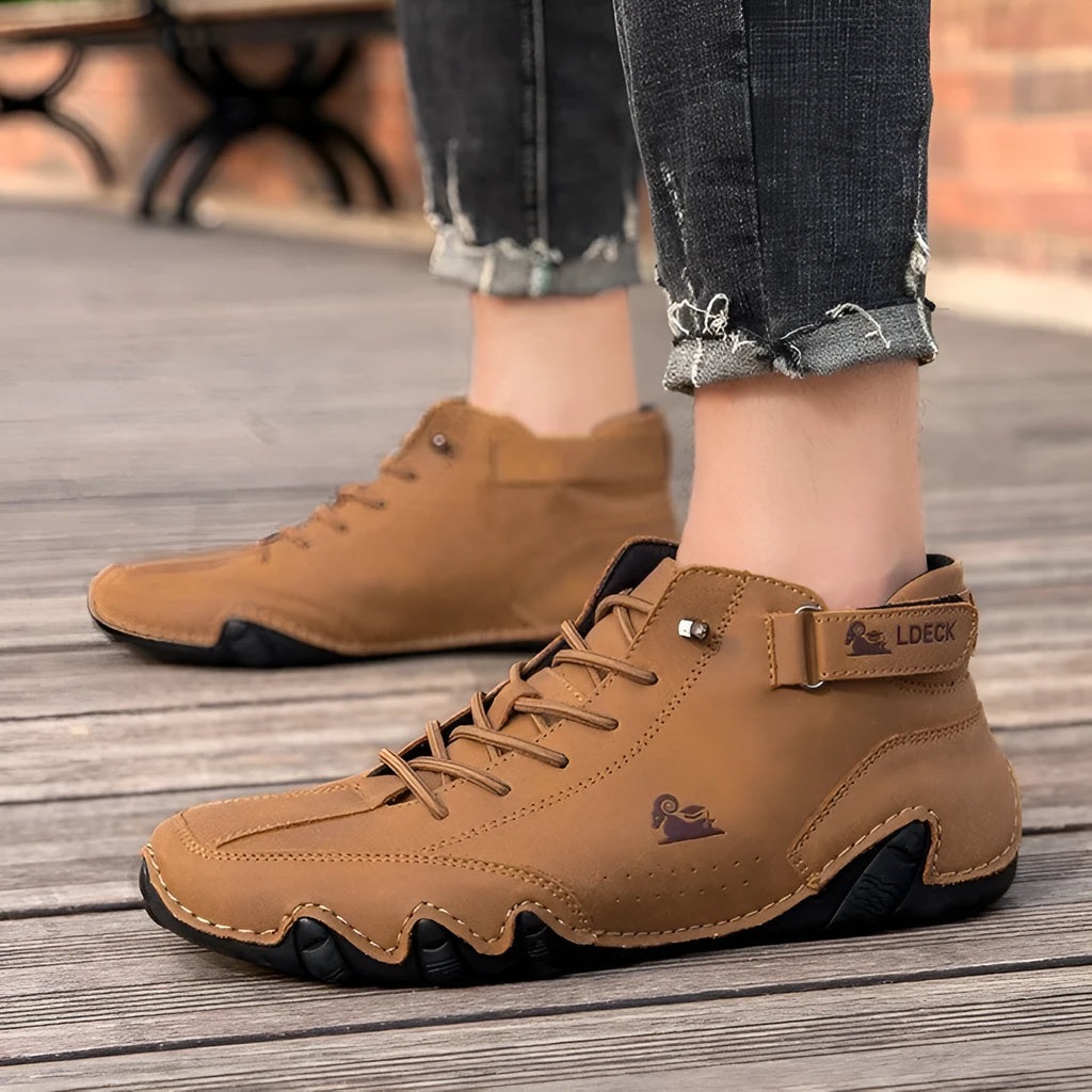 Men's khaki high top octopus shoes with round toe and mid-cut design on a rubber sole.
