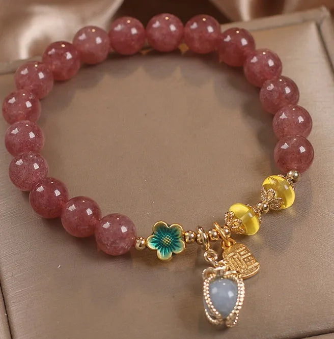Red women's bracelet with natural strawberry quartz beads, alloy settings, and rhinestone decorative elements