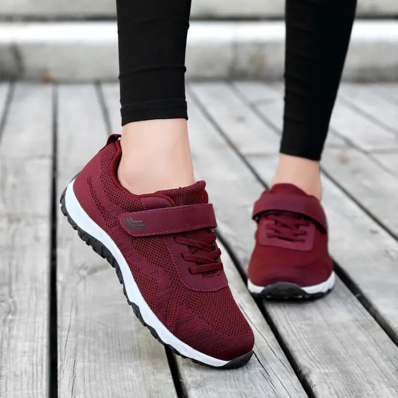 Women's low-top casual shoes with wedge heel, mesh upper, and Velcro closure in solid colours