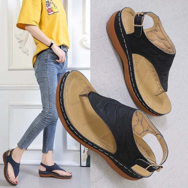 Women's wedge heel sandals with an adjustable buckle strap in a solid colour