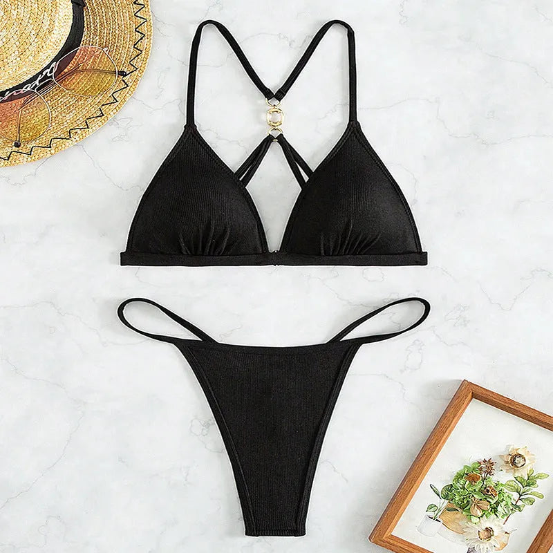 Black women's hollow backless split bikini set with triangle top on a mannequin.