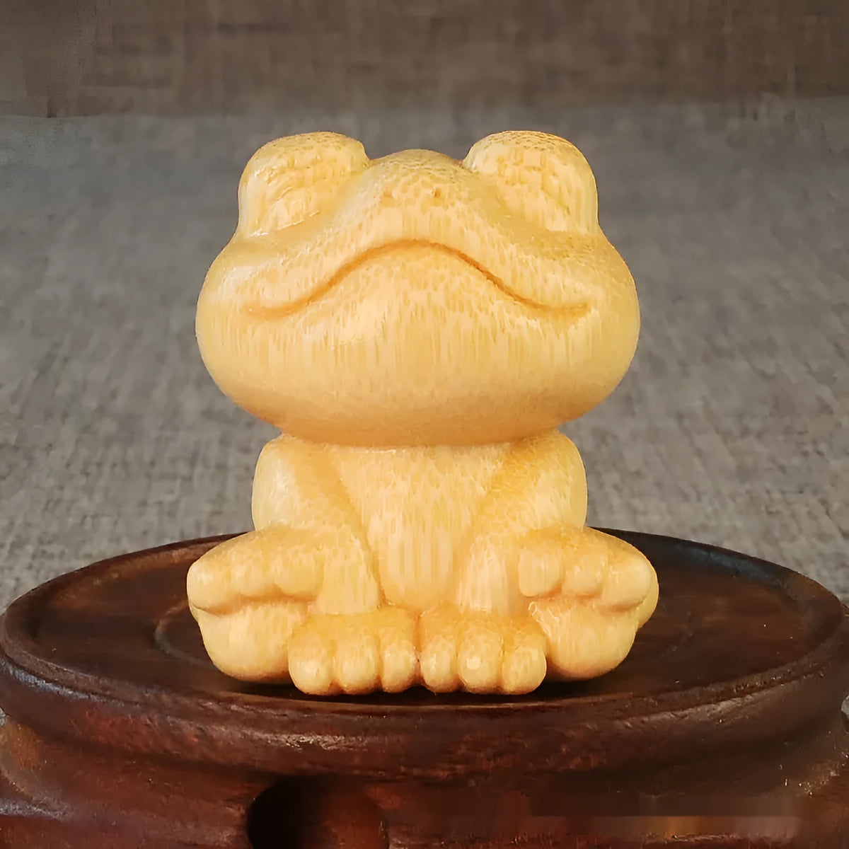Solid bamboo smiling frog carving ornament measuring 5cm height with cartoon style design
