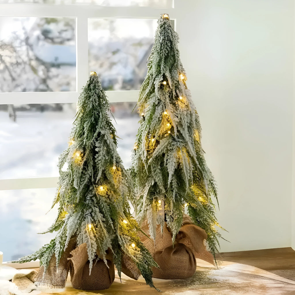 24-inch desktop artificial Christmas tree with LED lights and white snow finish on plastic branches