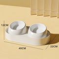White elevated pet feeder with two tilted bowls on a stable plastic base, for cats and small dogs.