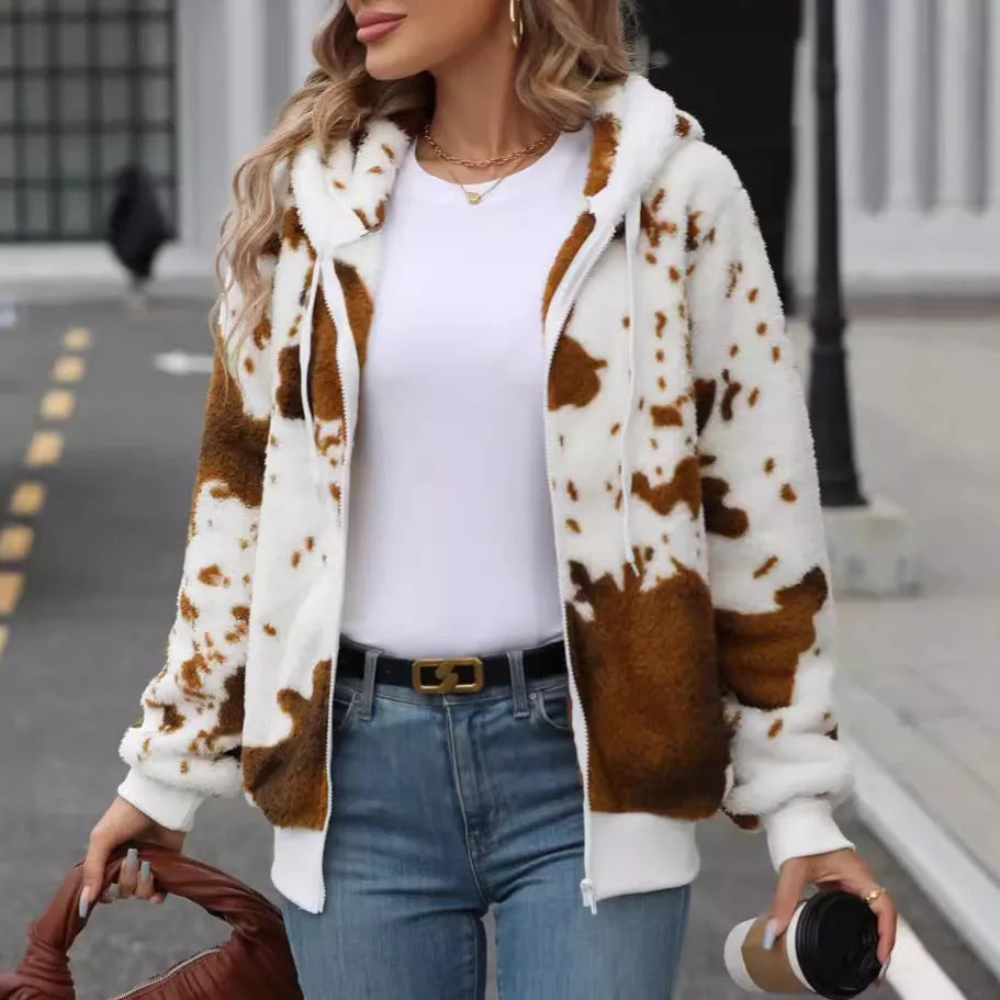 Yellow brown cow animal print hooded cardigan jacket with full zipper on a model.