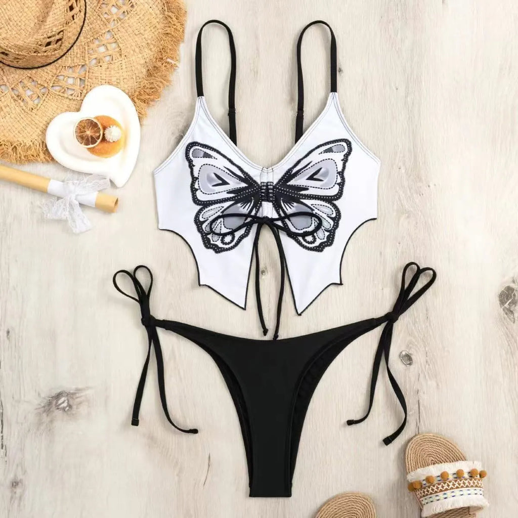 Women's purple bow ins style split bikini set with briefs, on a mannequin.