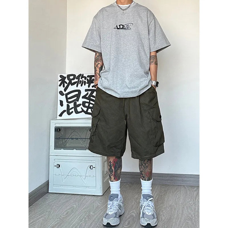 Man wearing loose straight-leg casual shorts in polyester fabric, available in black, blue, green, and khaki colours.