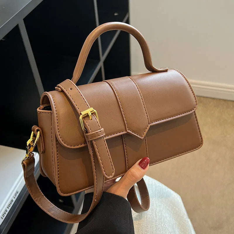 Women's beige messenger bag with adjustable strap showing internal file compartment and outer sandwich pocket