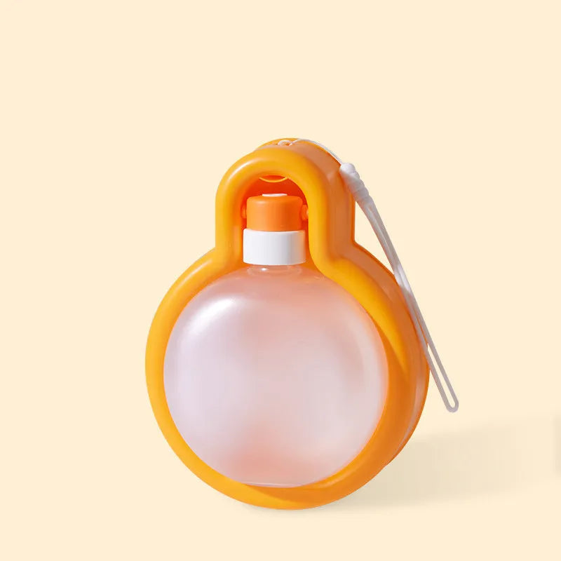 Green portable pet travel cup with handle, showing pull-out drinking bowl for dogs.