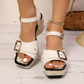 White women's square-toe chunky heel sandals with a prominent metal buckle fastening on the strap.