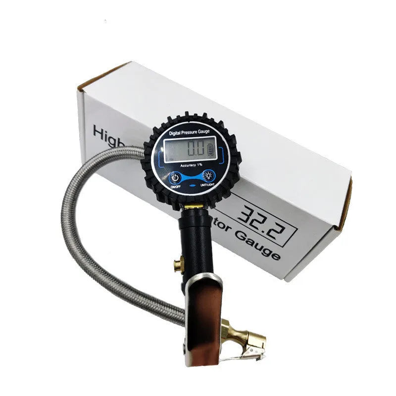 Digital tire pressure gauge with black silver metal body, backlit display, and braided hose on a tyre valve