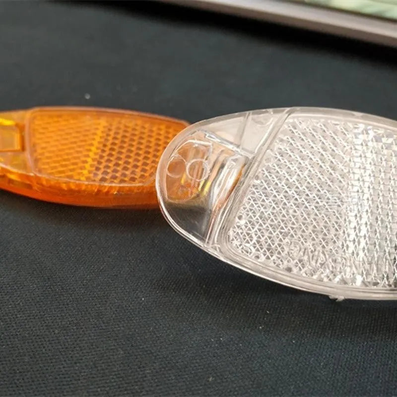 White and yellow plastic bicycle reflector spoke decorations for front and rear wheel safety lighting