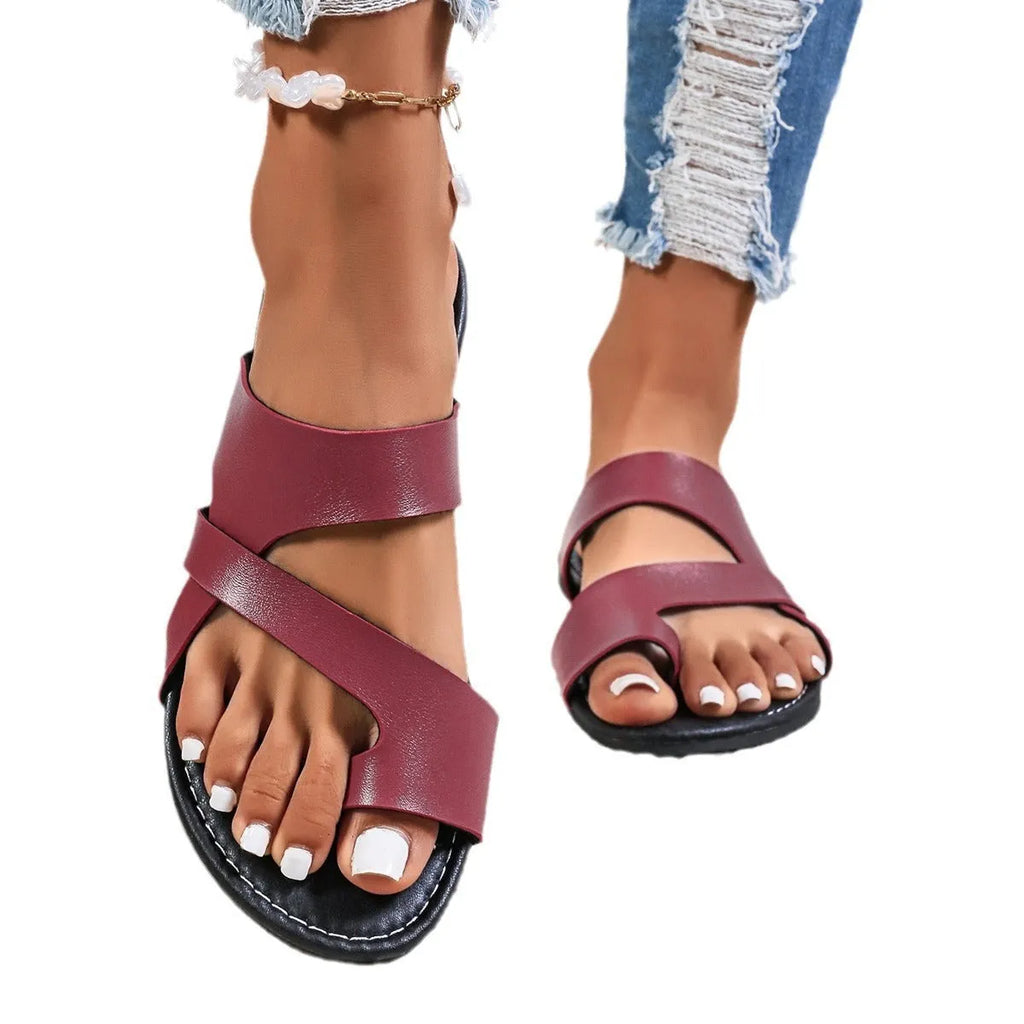 Adult beach slippers with hollow-out design in black, brown, and wine red colours showing rubber sole