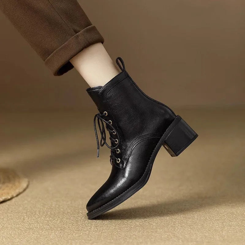 Women's black and brown pointed-toe ankle boots with a 5.5cm heel on a plain background