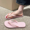 Men's PVC toe-covering flip flops on a solid colour background, showing the non-slip sole and range of available colours.