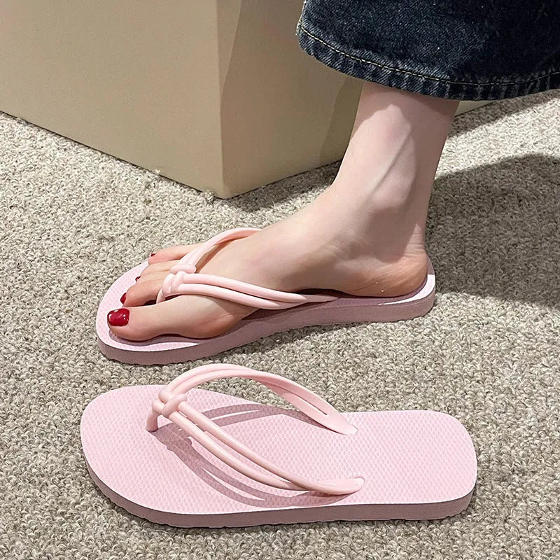 Men's PVC toe-covering flip flops on a solid colour background, showing the non-slip sole and range of available colours.