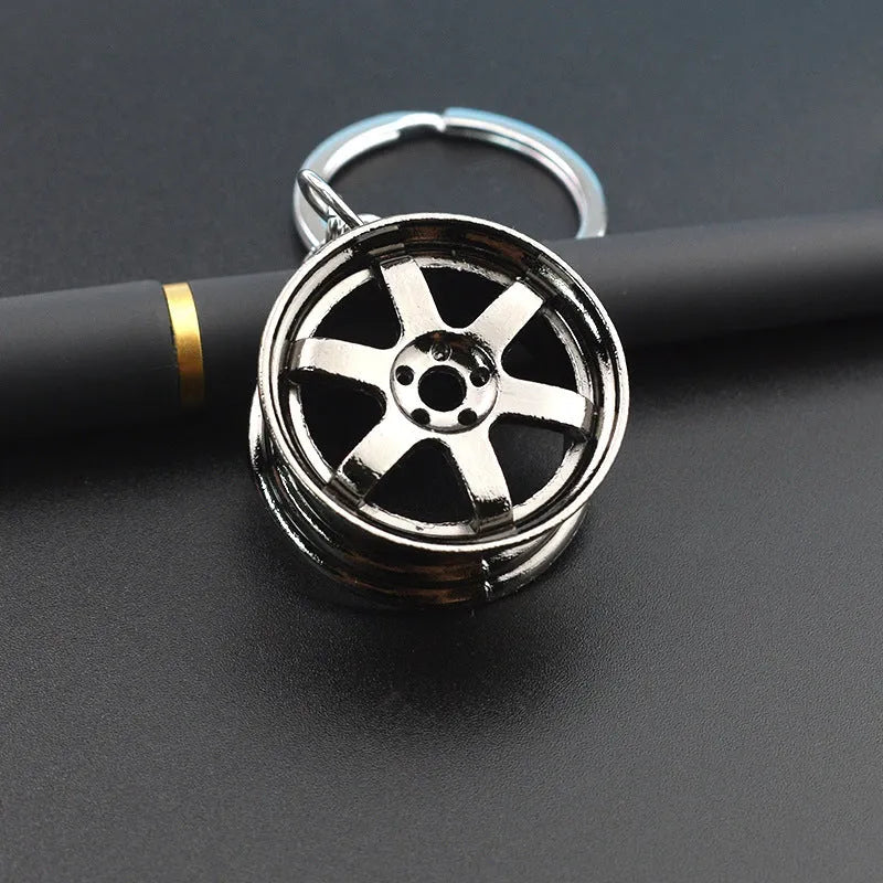 Creative car modification wheel hub metal keychain in gold finish on a keyring