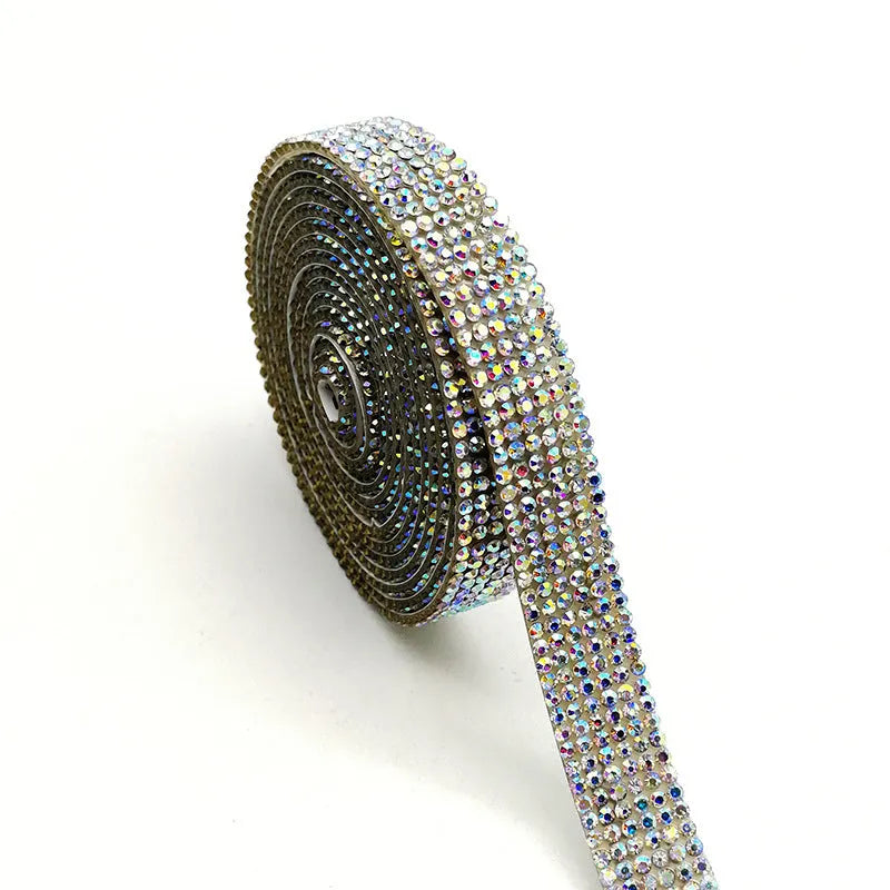Close-up of a self-adhesive electroplated glass crystal strip on a roll for clothing decoration.