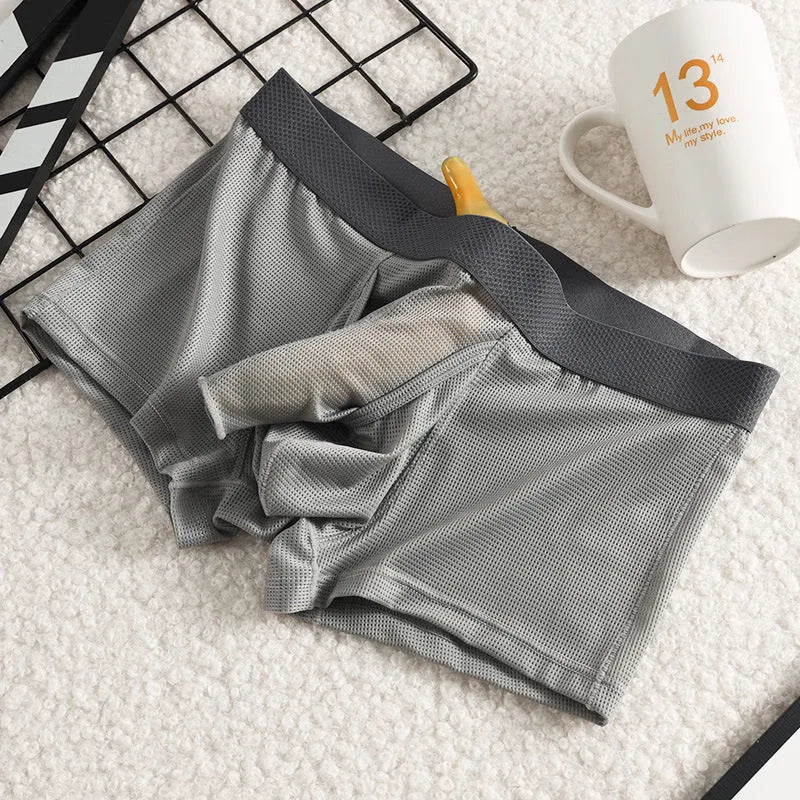 Men's solid colour ice silk boxer shorts on a white background, showing low waist design.