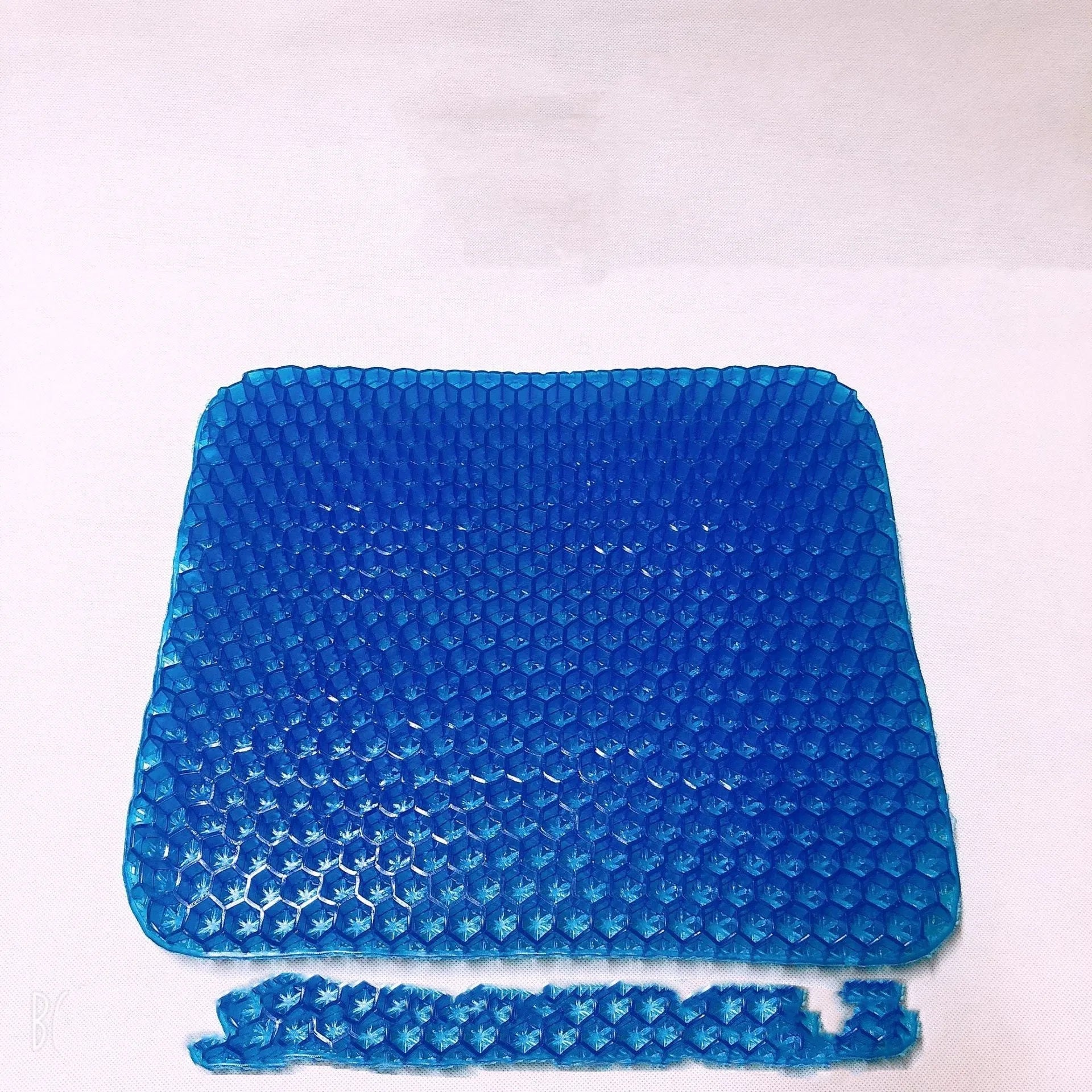 Square gel seat cushion with honeycomb design showing double-thick construction for pressure relief