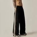 Man wearing black high-waist wide leg climbing pants made from polyester for casual leisure wear.