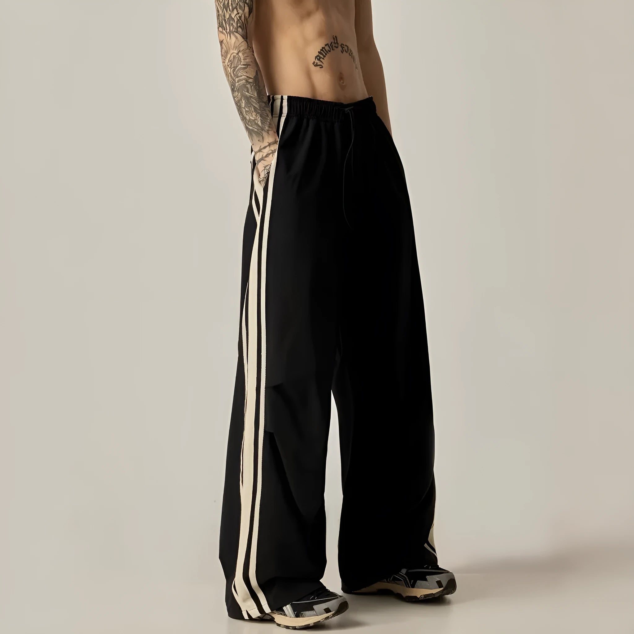 Man wearing black high-waist wide leg climbing pants made from polyester for casual leisure wear.