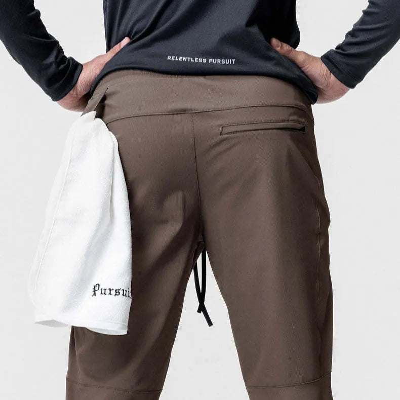 Men's dark grey quick-dry ankle-tie fitness pants shown in a loose fit.