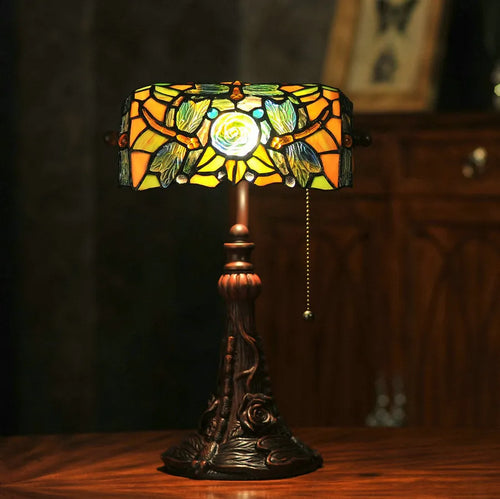 10-inch tall Tiffany table lamp with multi-coloured stained glass shade on a resin base.