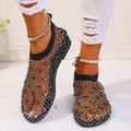 Colourful rhinestone detail on the mesh upper of women's white flat sandals with a round toe.