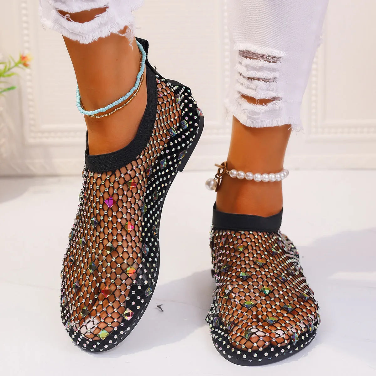 Colourful rhinestone detail on the mesh upper of women's white flat sandals with a round toe.