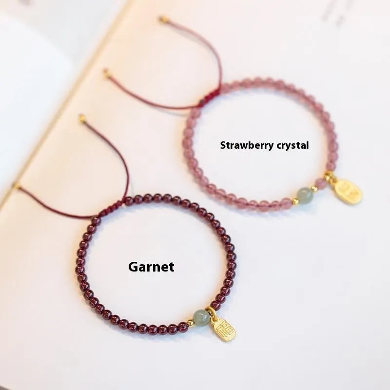 Hand-woven red rope bracelet with strawberry quartz crystals and garnet beads