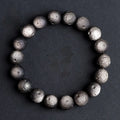 Natural obsidian crater ball bracelet in silver stone or gold finish, showing textured bead detail.
