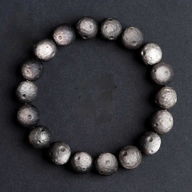 Natural obsidian crater ball bracelet in silver stone or gold finish, showing textured bead detail.
