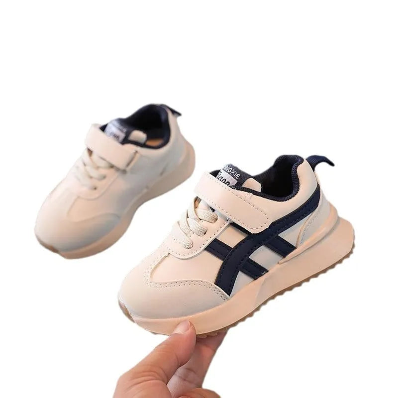 Children's solid-colour Velcro sneaker in beige with a rubber sole and synthetic leather upper.