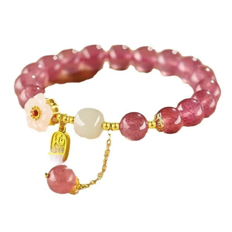Handmade strawberry quartz crystal bracelet with a choice of moon, XINGX, or pearl charm on a natural crystal band.