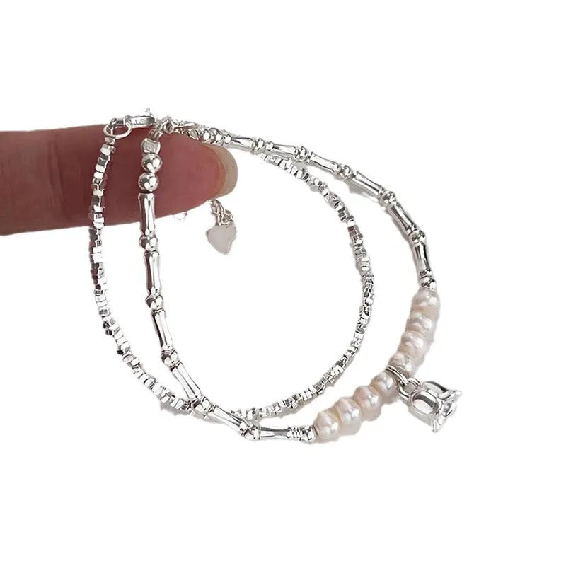 Silver pearl Lily of the Valley pendant bracelet on display