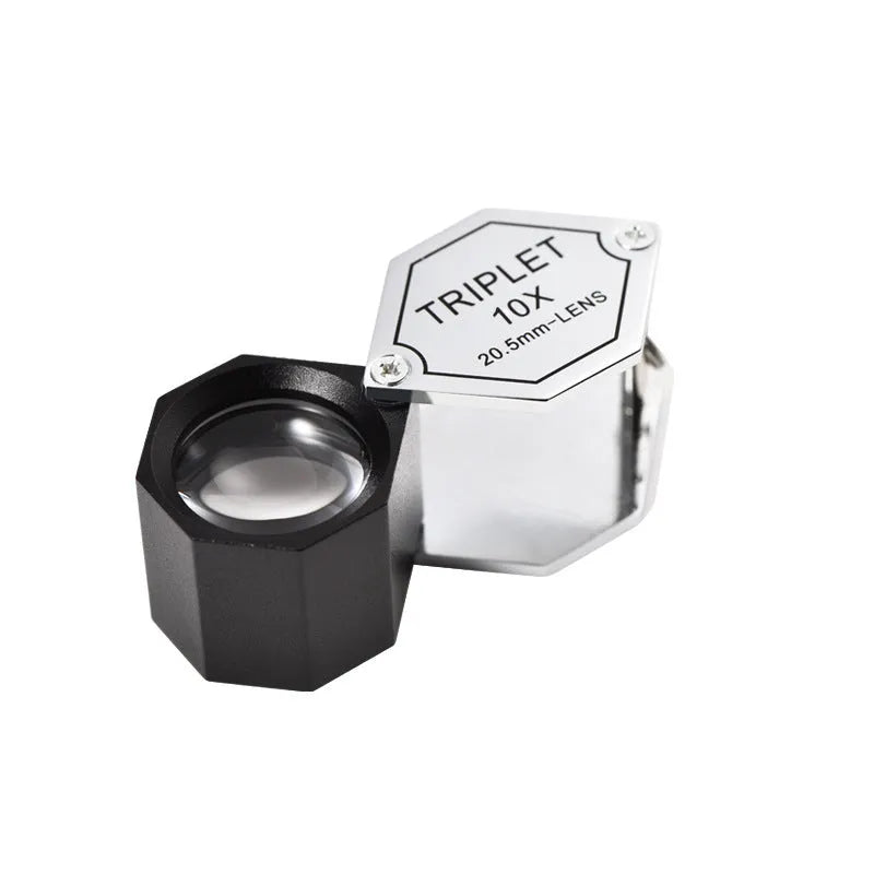 Handheld metal magnifying glass with optical glass lens for jewellery and coin identification.