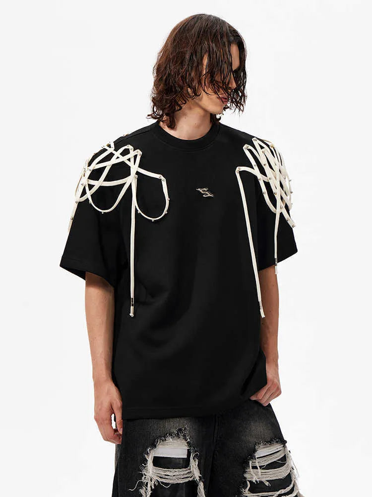 Black loose fit short sleeve t-shirt with rivet ribbon detail on padded shoulders.