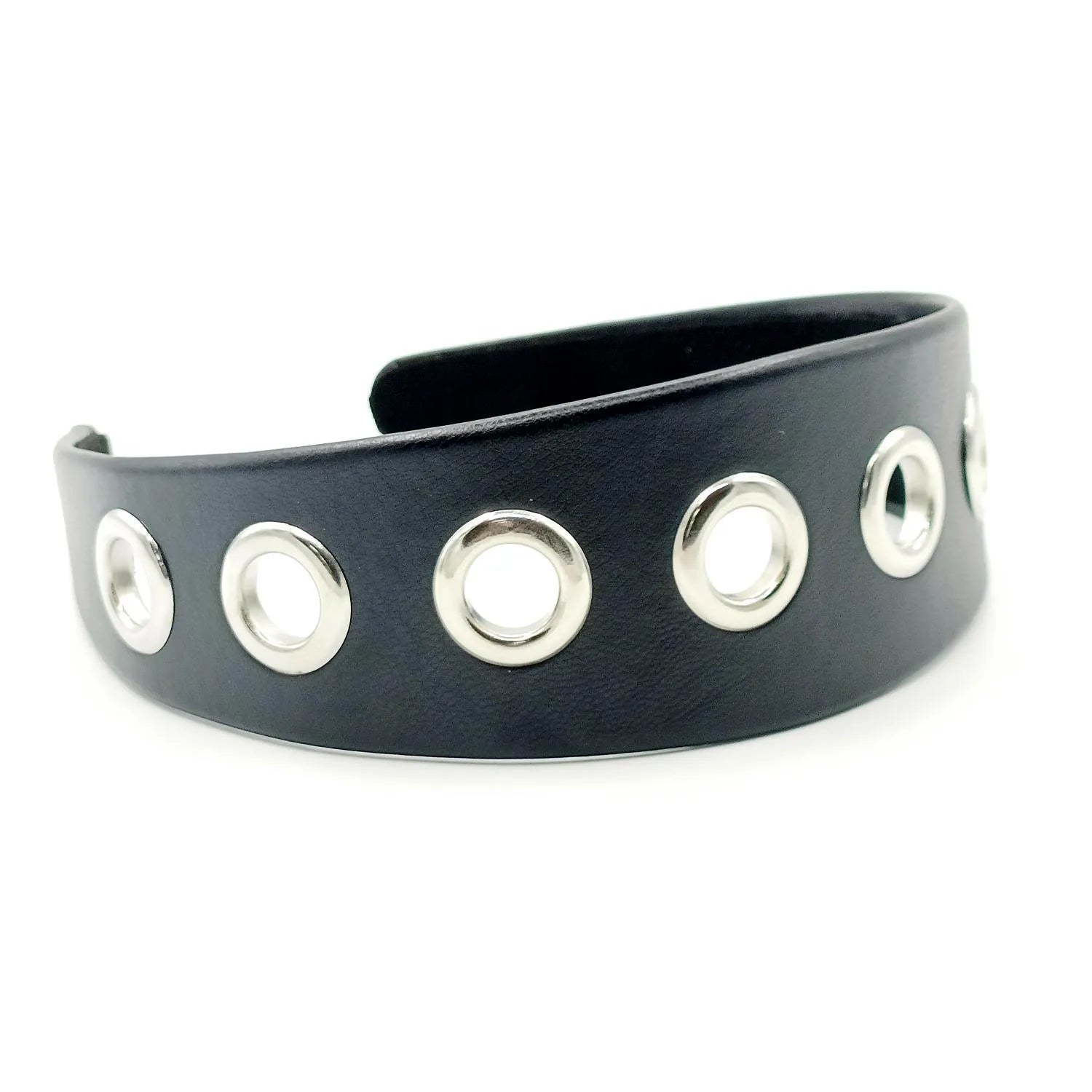 Wide black faux leather headband with round, square, and dotted rivets on a white background