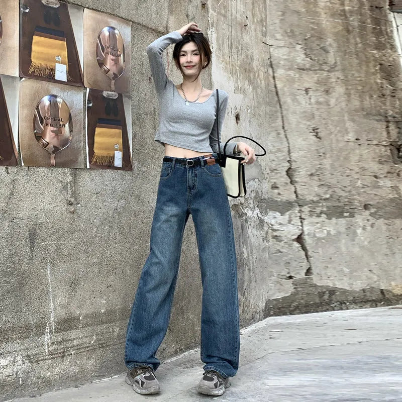 Women's retro blue straight leg jeans with a high waist, shown on a hanger.