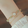Women's yellow gold electroplated copper butterfly bracelet with geometric shell flower design and Hetian jade stone.