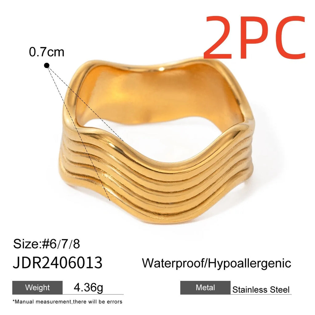 Stainless steel wide wave ring with geometric design and electroplated finish.