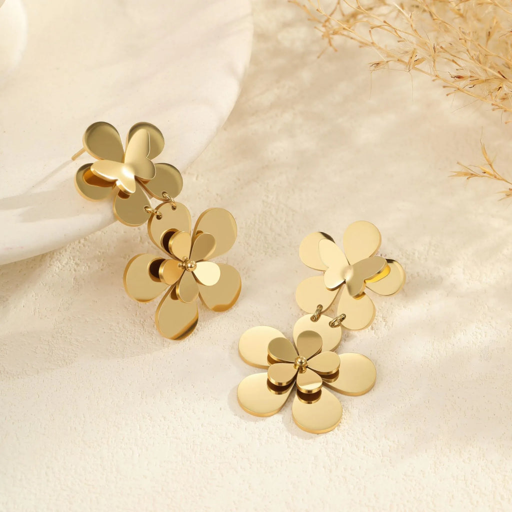 Gold-coloured flower butterfly earrings with geometric design elements on stainless steel