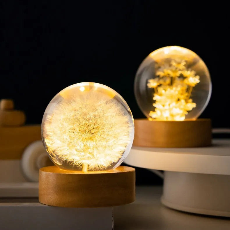 3D dandelion crystal ball LED night light on a beech wood stand, showing USB cable.