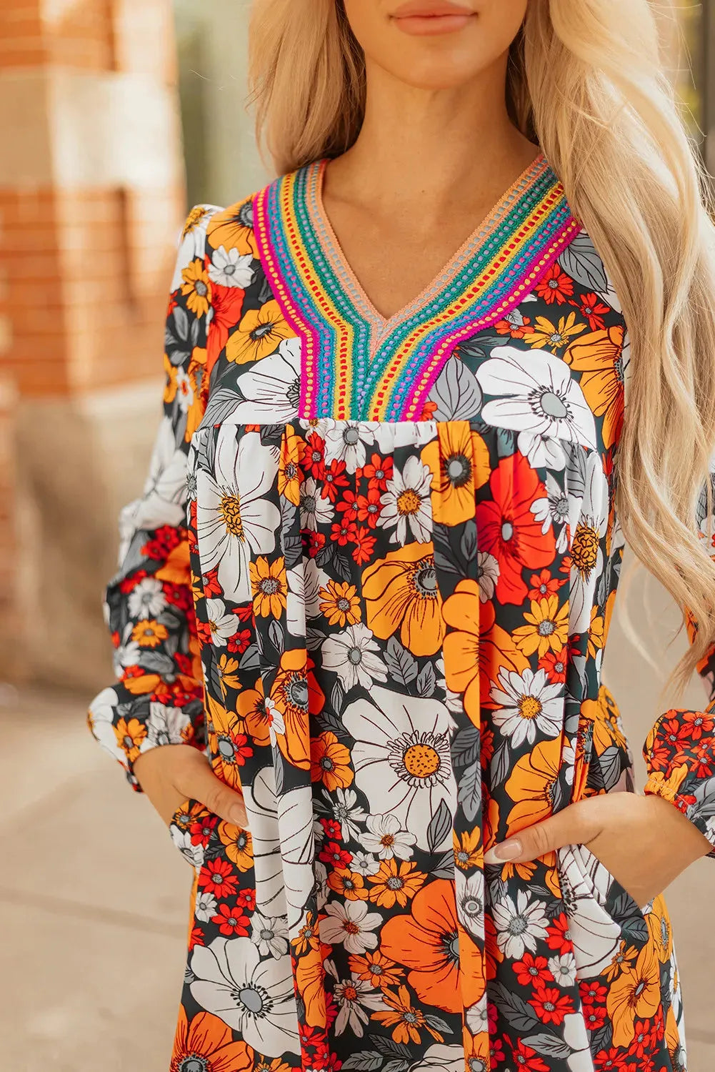 Orange floral print mini dress with V neck, long sleeves and vertical striped lace detailing