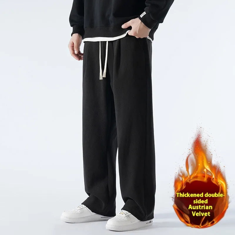Men's apricot coloured loose-fit fleece-lined winter sports trousers with a drawstring waist laid flat.