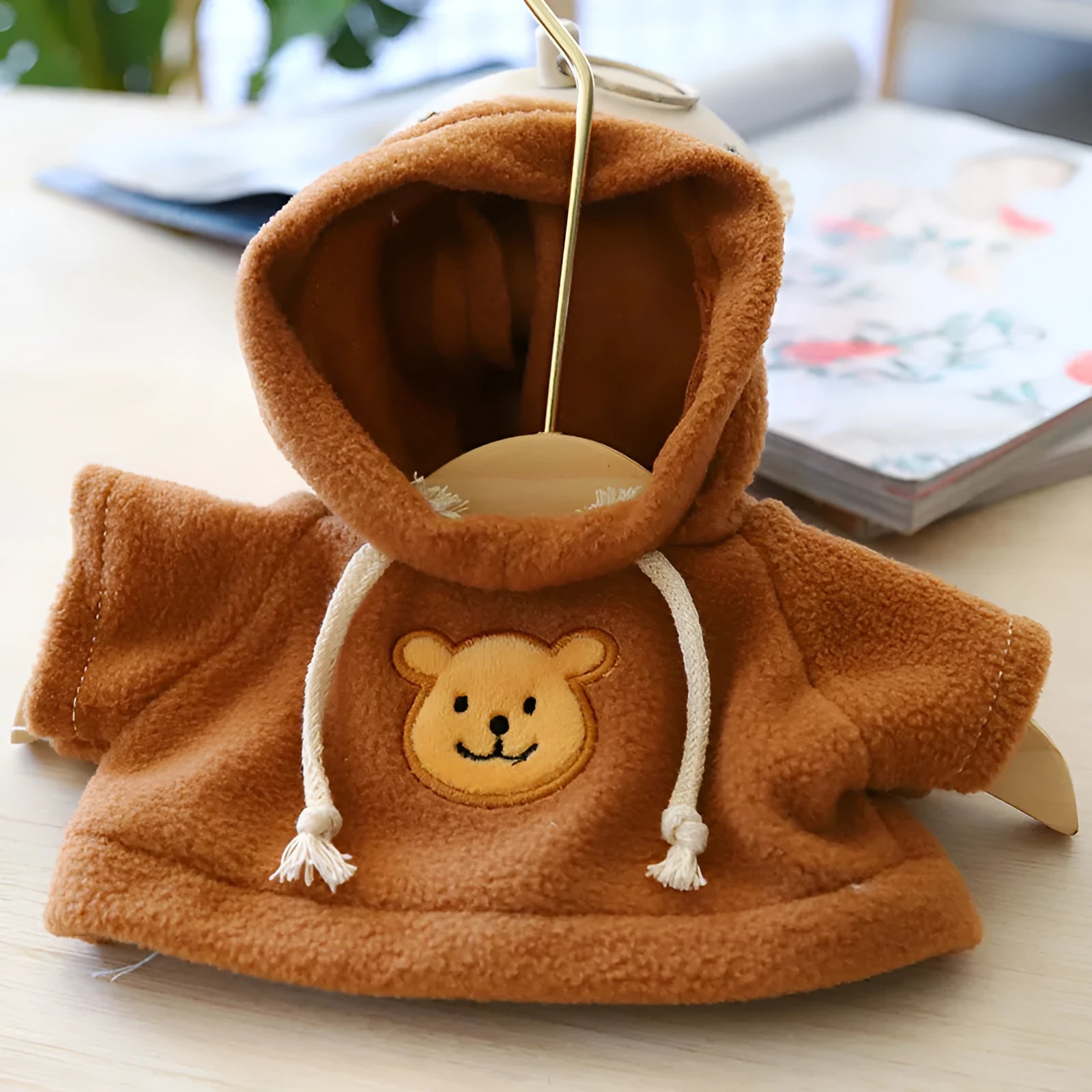 A blue balaclava-style hoodie sweater for a small dog or cat on a white background.