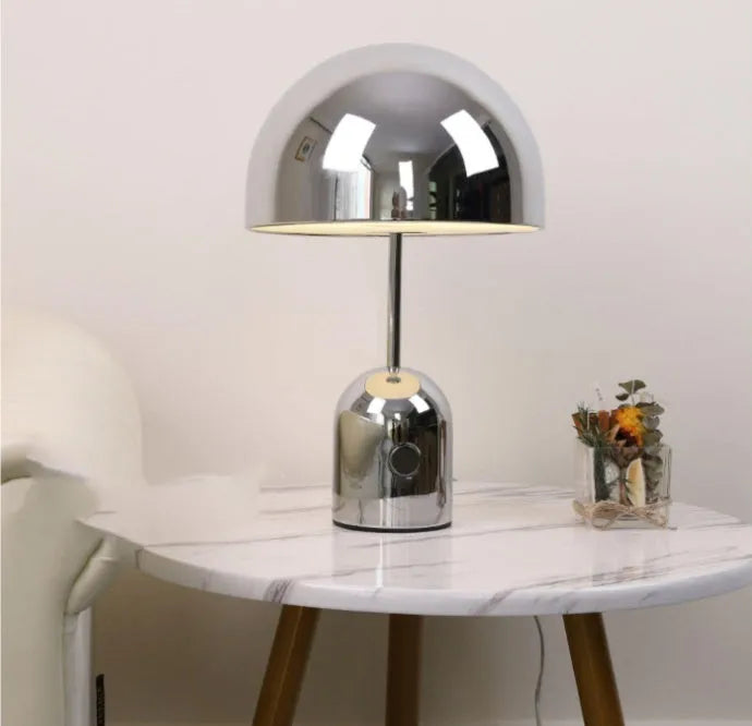 Post-modern metal table lamp with 280mm diameter in rose gold finish on wooden surface